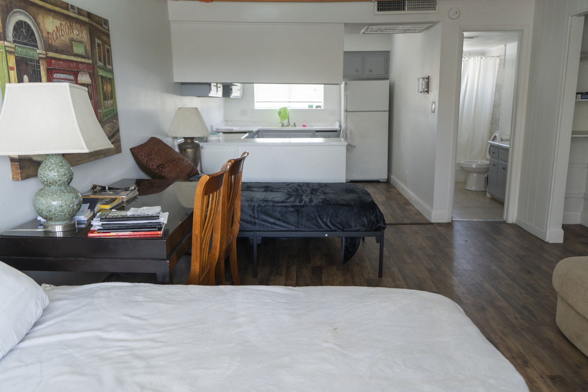 Bedroom with kitchenette and bathroom in open floor layout