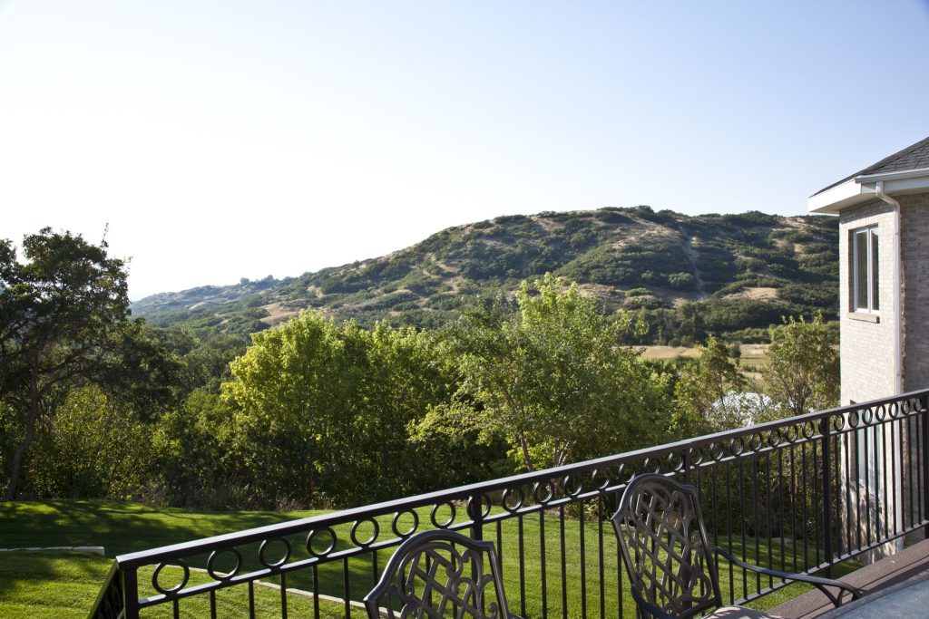 Balcony overlooking mountains and landscaped grounds