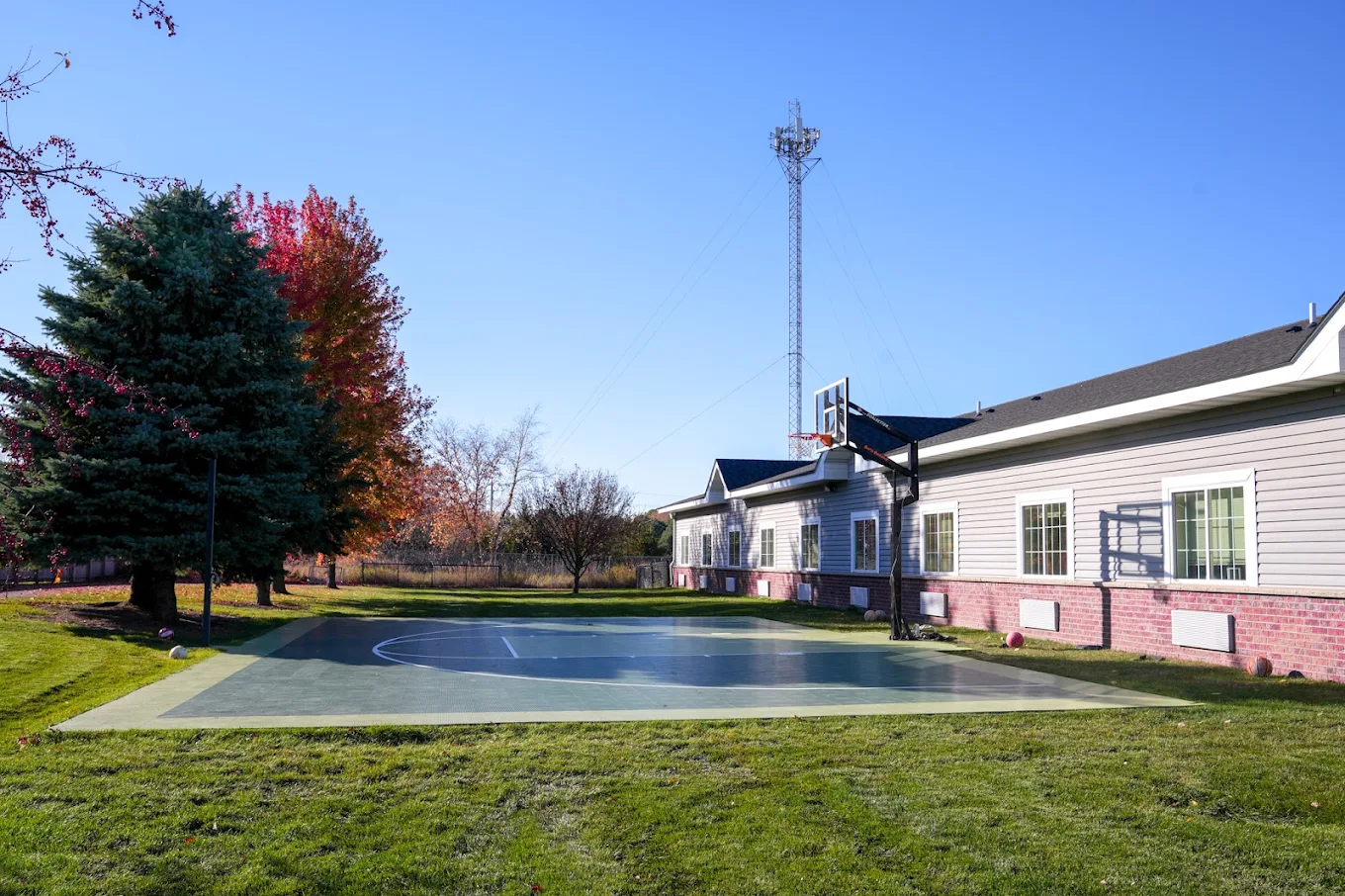 Basketball court in a backyard of a rehab center.