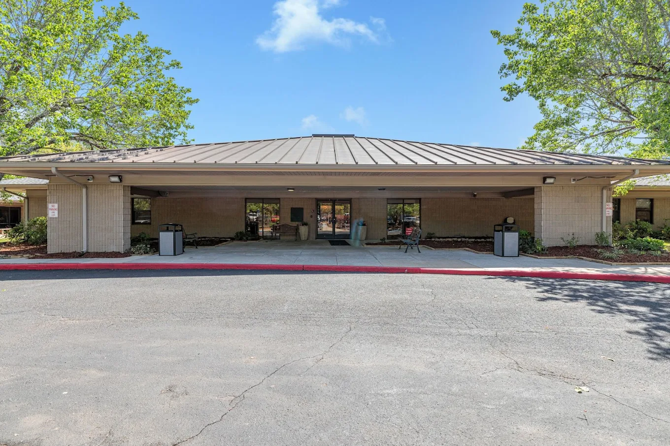 Covered entrance of the facility with walkway and seating