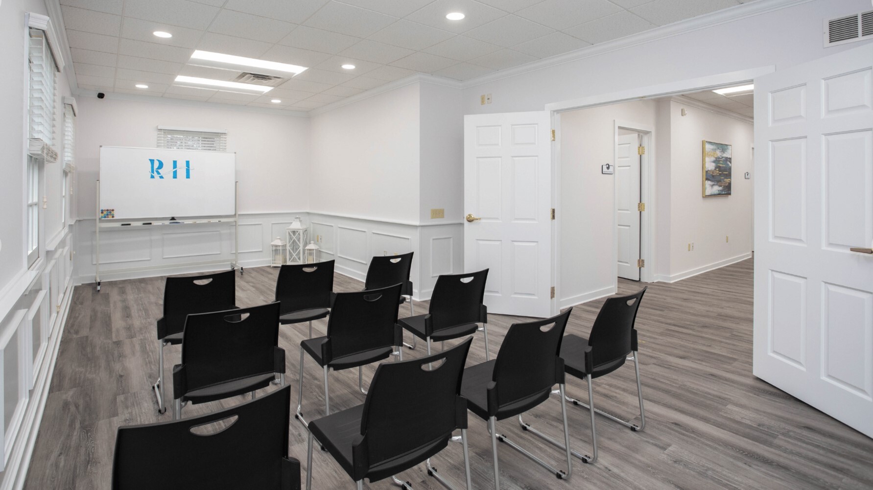 Classroom with chairs arranged in front of a whiteboard.