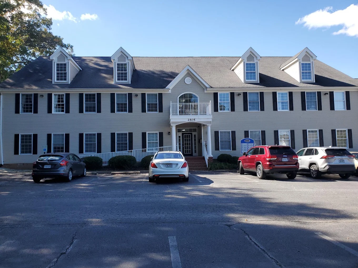 Two-story treatment facility with parking area in front