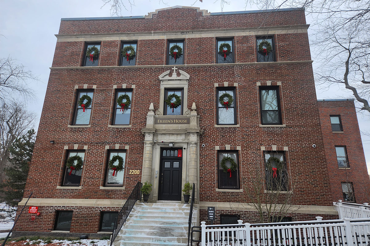 Brick building with wreaths and “Eileen’s House” sign