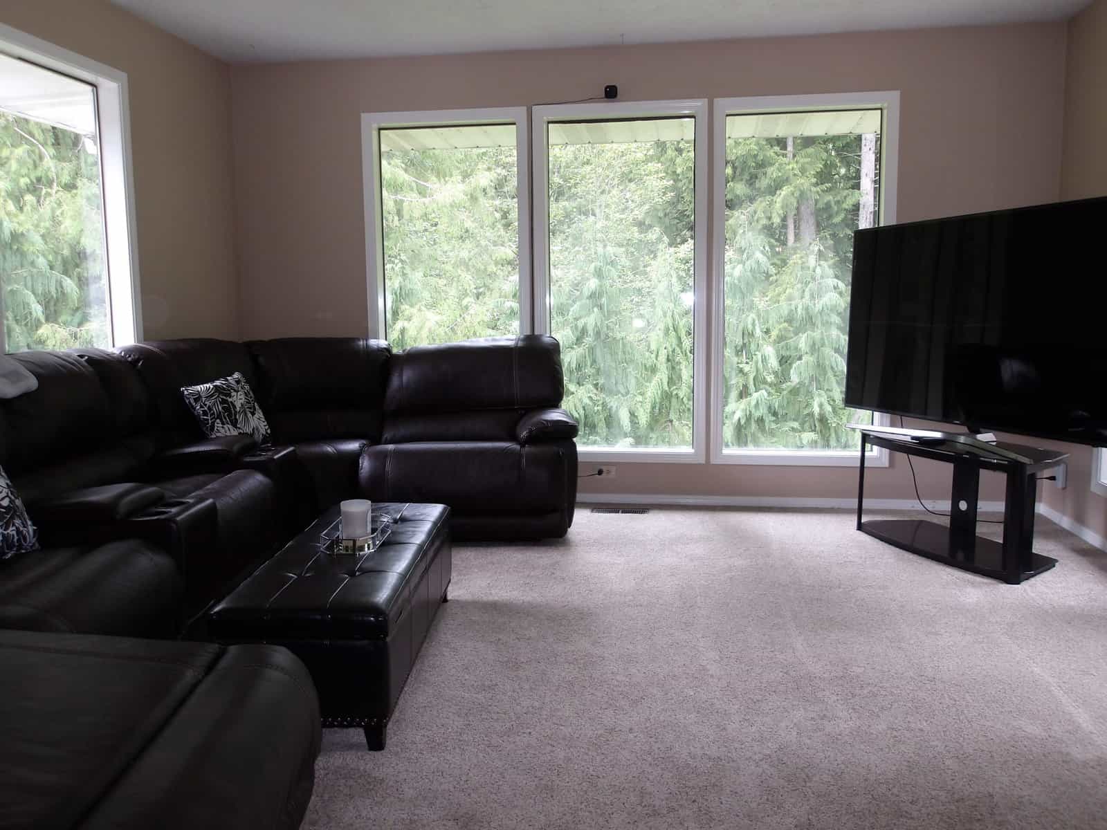 Outpatient living room with leather couches and large windows