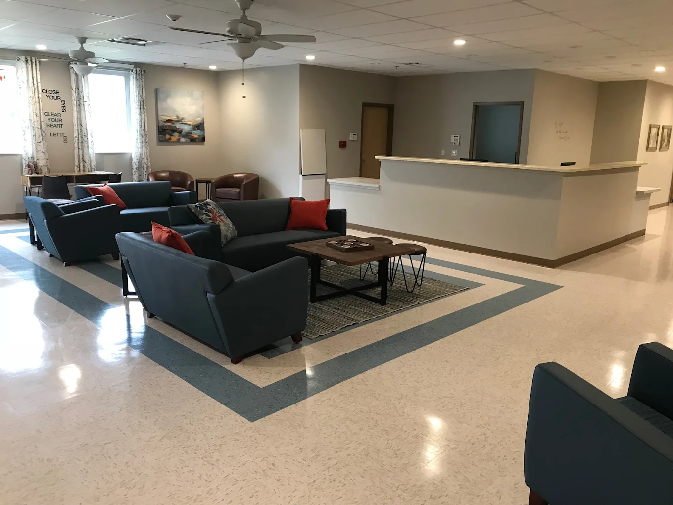 Lounge area with couches, side tables, and bright decor