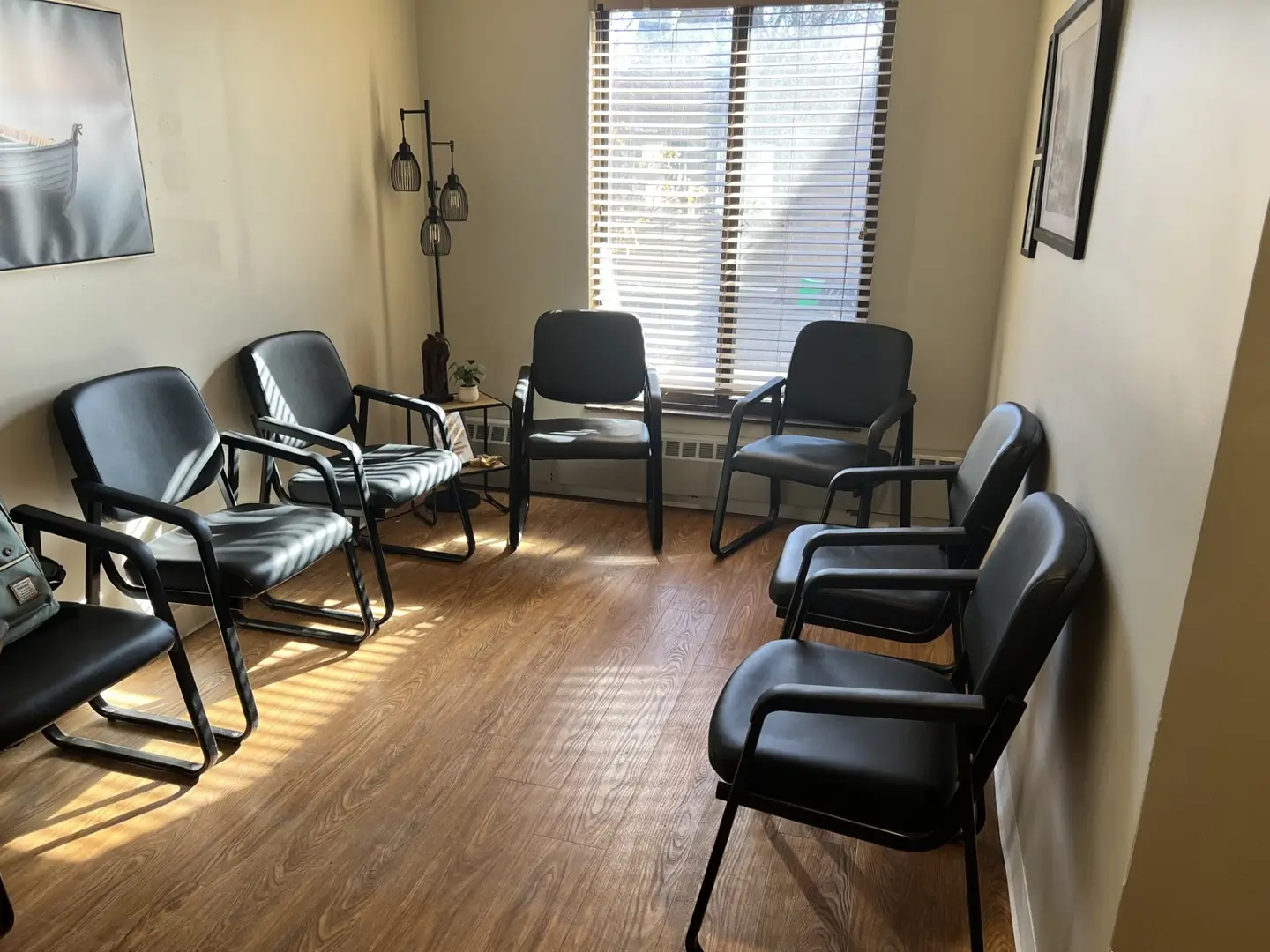 Circle of chairs in a group therapy room with natural light