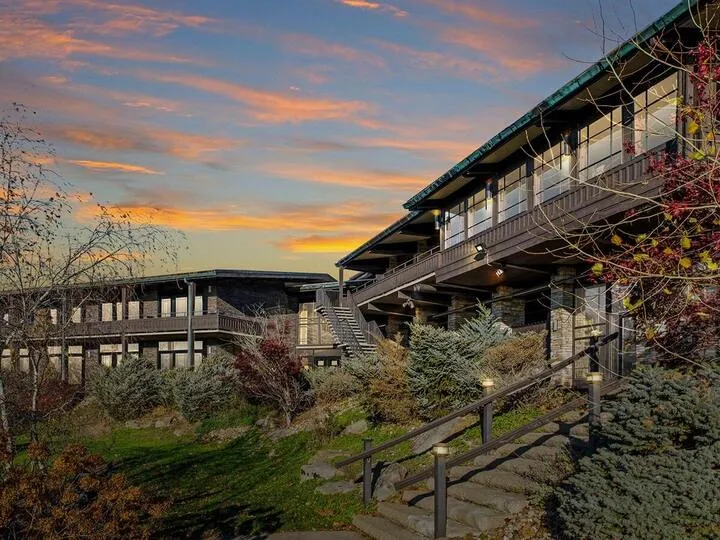 Lodge-style facility and landscaped grounds at sunset