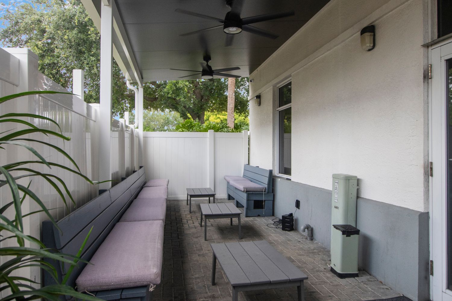 Outdoor patio with cushioned benches and tables