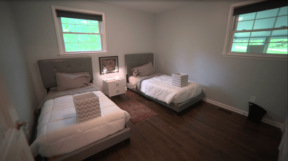 Shared bedroom with two twin beds and nightstand