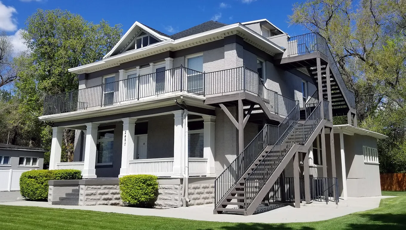 Side view of rehab facility with exterior stairs and balcony