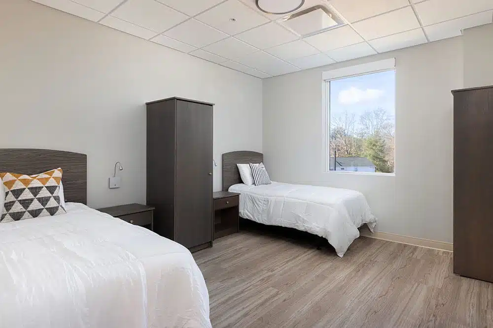 Bright shared bedroom with two twin beds and modern furnishings