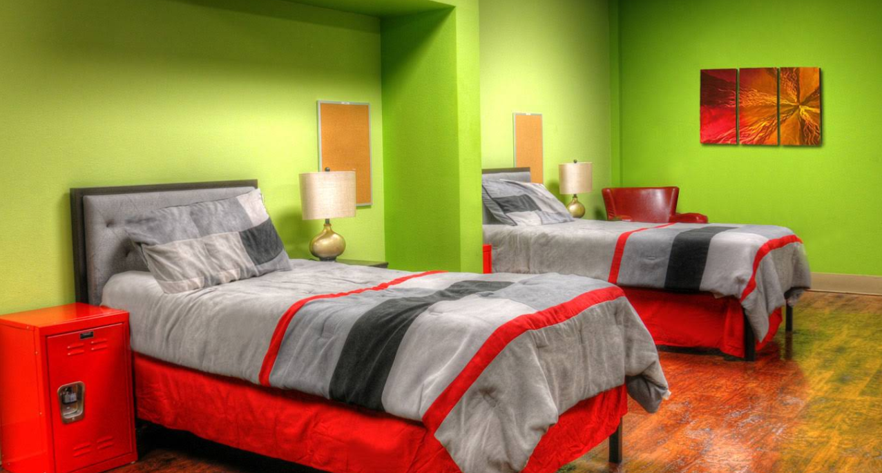 Shared bedroom with twin beds and green walls