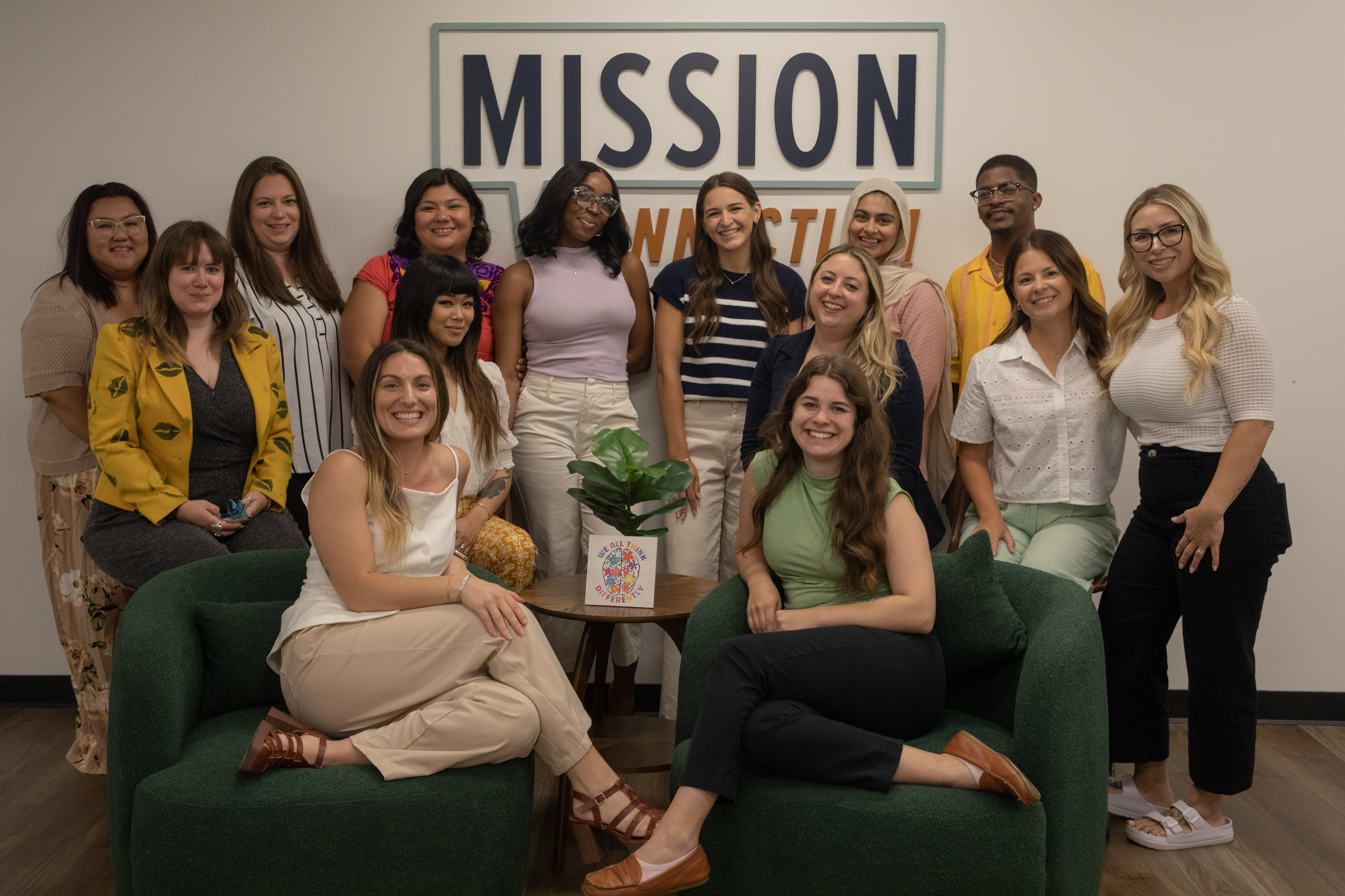 A group of ladies on green couches and Mission Connection.