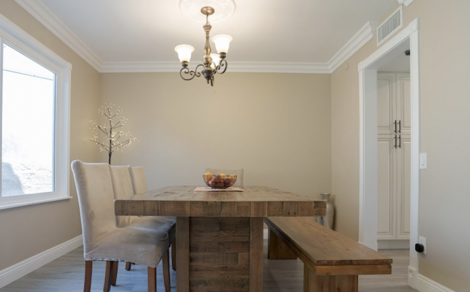 Dining room with rustic table, bench seating, and soft lighting