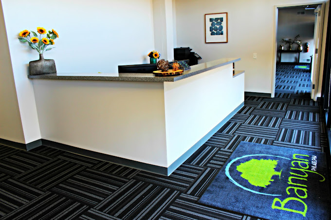 Reception area with "Banyan" signage on a mat.