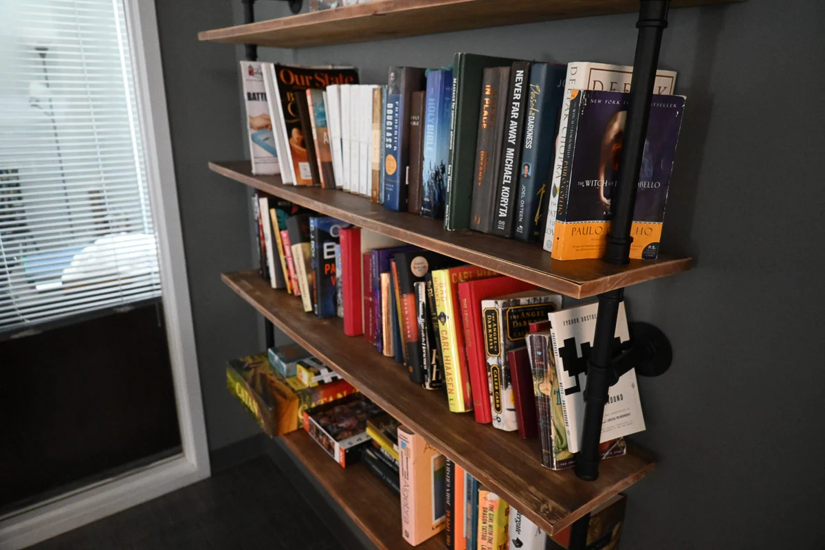 Wooden bookshelf filled with books and reading materials