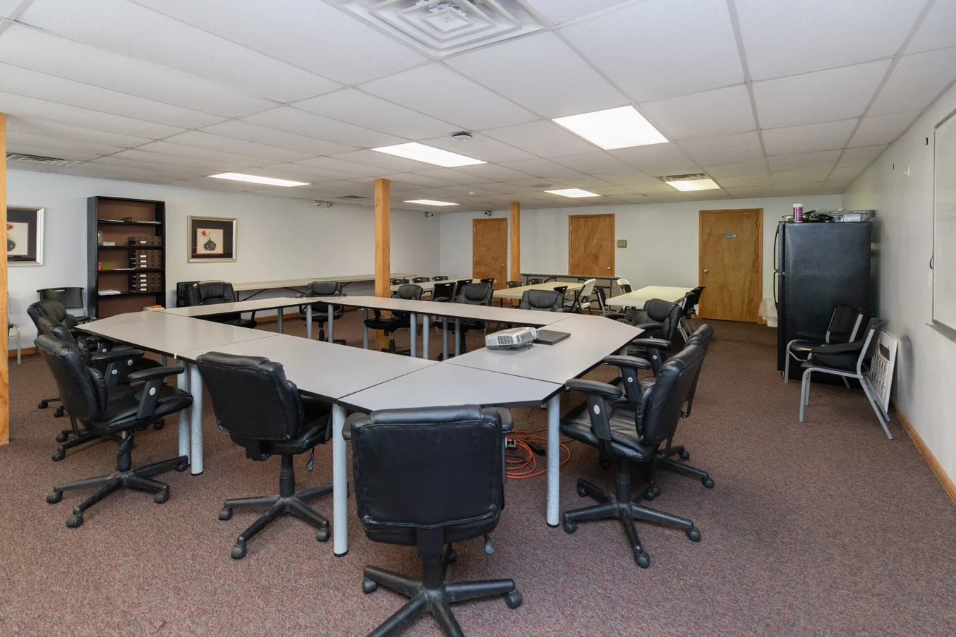 Group therapy room with chairs and tables in U-shape