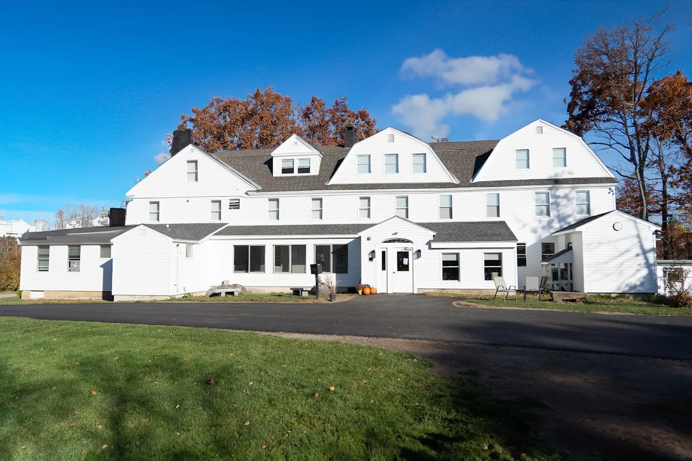 Large white multi-story building with dormer windows