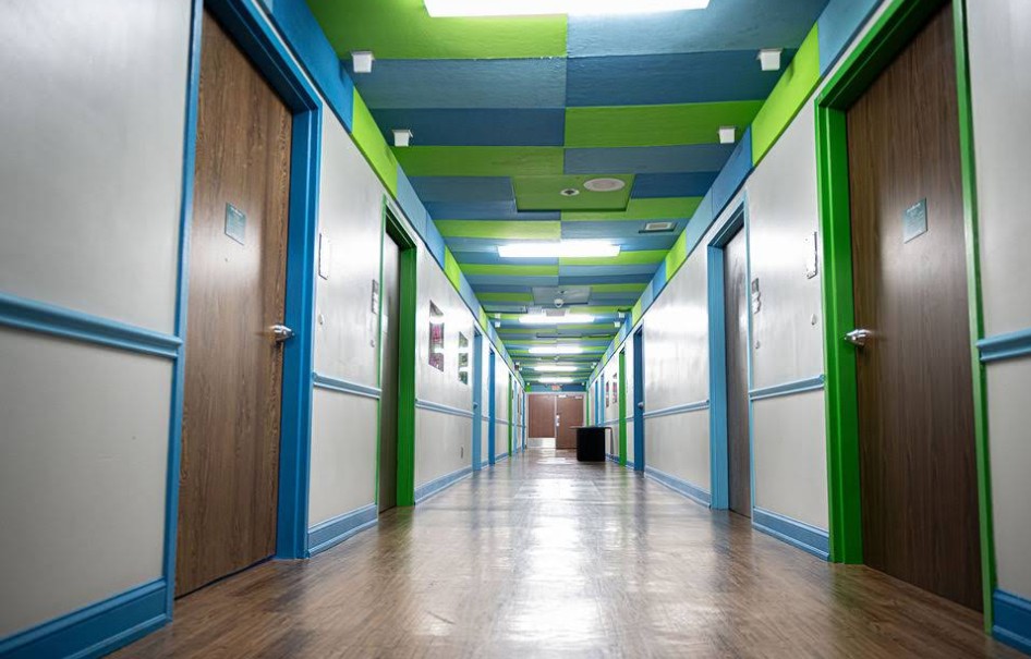 Colorful patient hallway with private room entrances