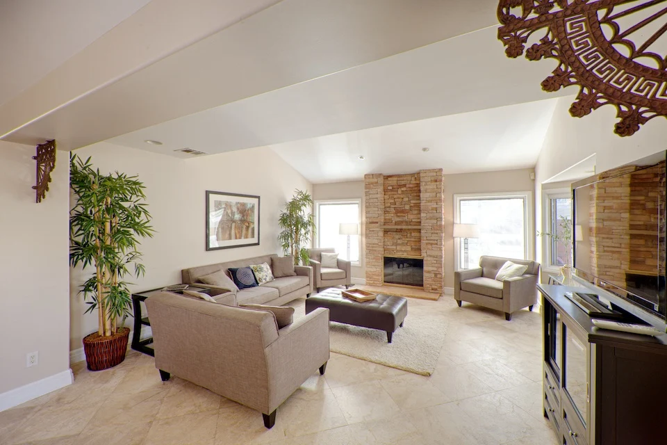 Cozy living room with sofas and a stone fireplace