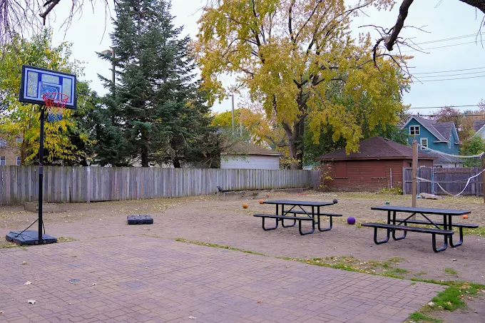 Courtyard with picnic tables and basketball hoop