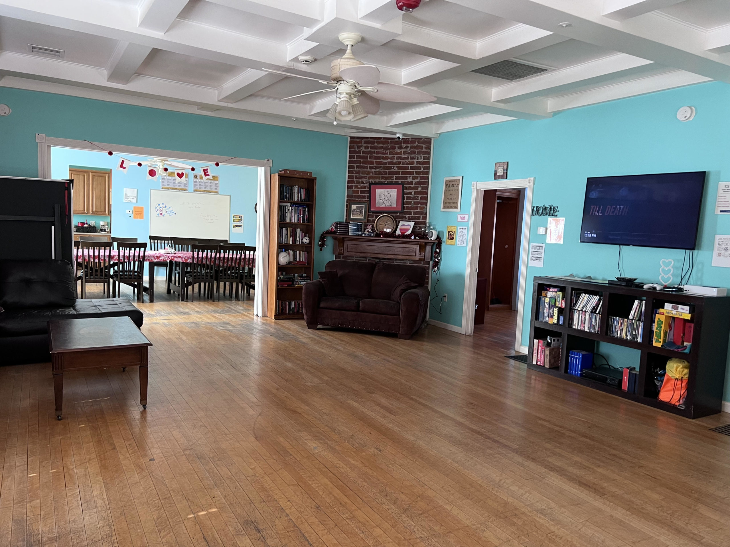 Spacious lounge with TV, bookshelves, and open layout
