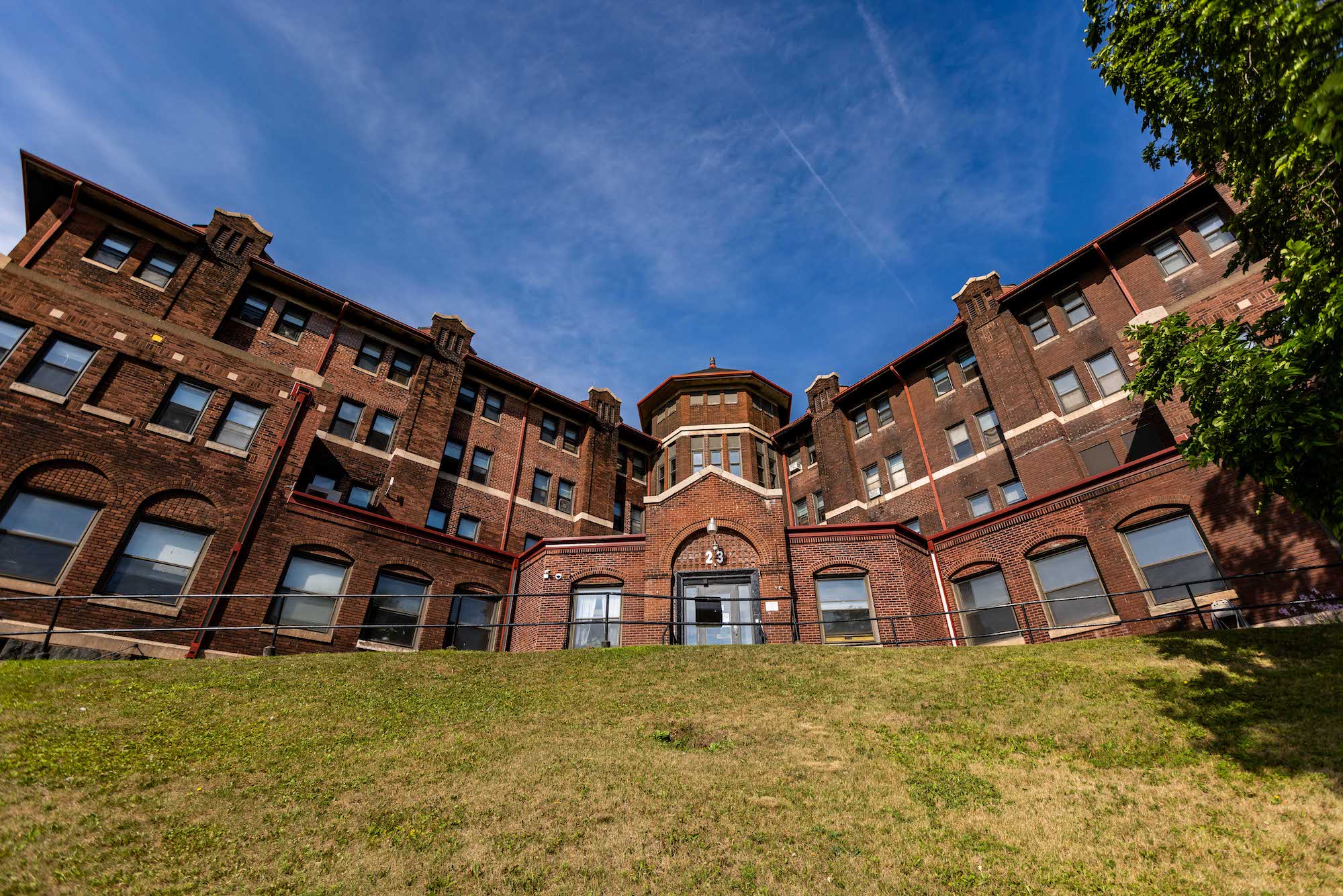 Brick rehab facility exterior under blue sky