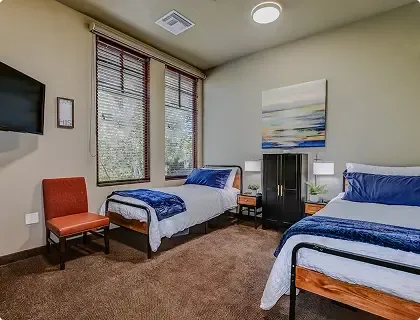 Shared bedroom with two beds and TV