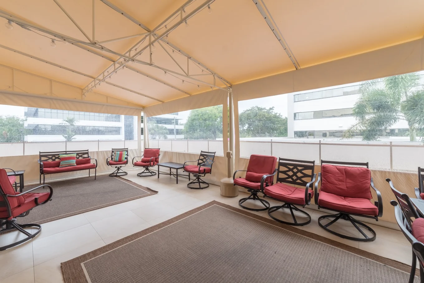 Outdoor seating area under a large covered veranda