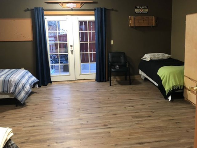 Room with two beds and double glass doors