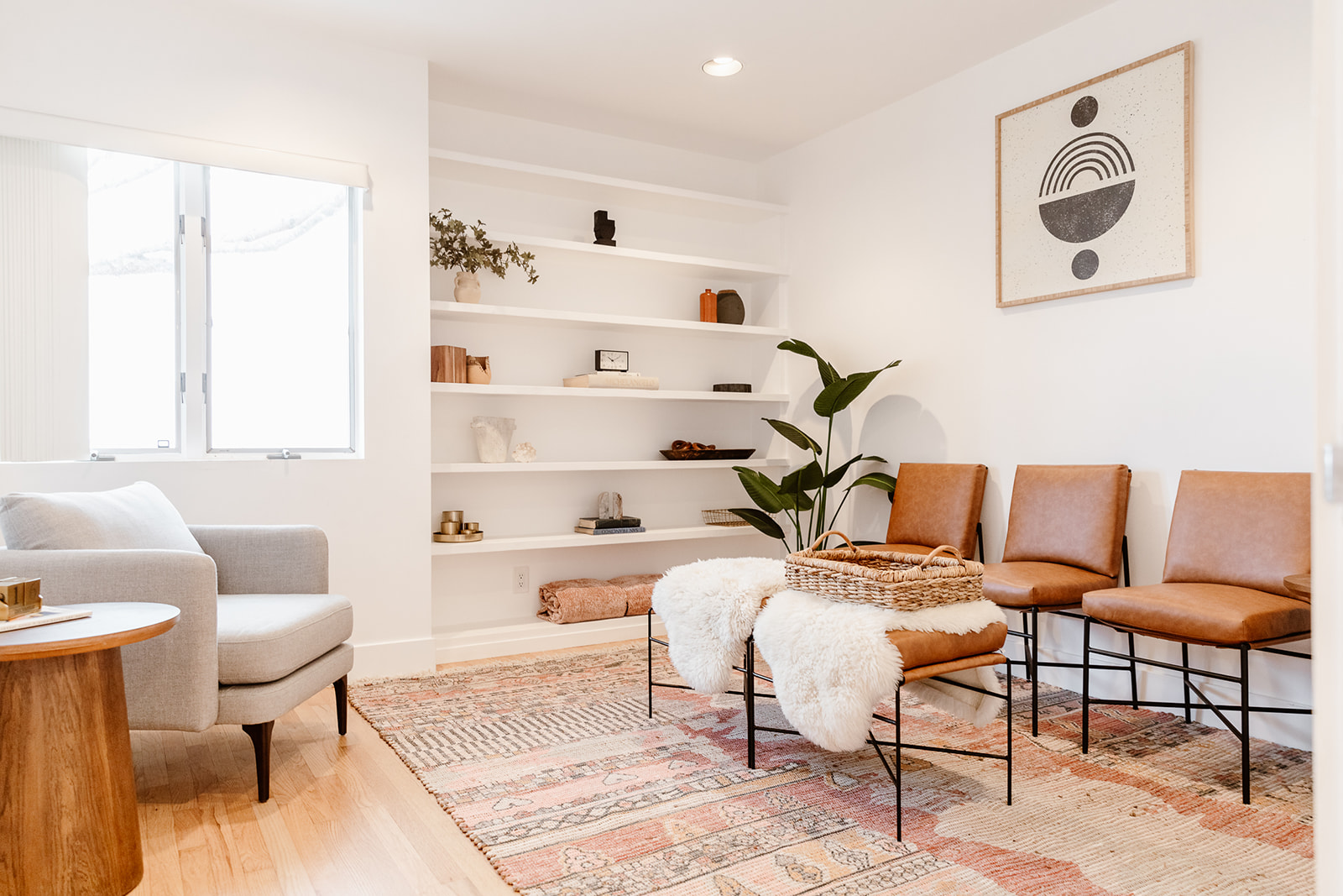Cozy lounge with warm-toned decor, built-in shelving, and soft lighting.
