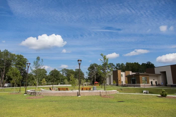 Landscaped campus lawn with walking paths and seating