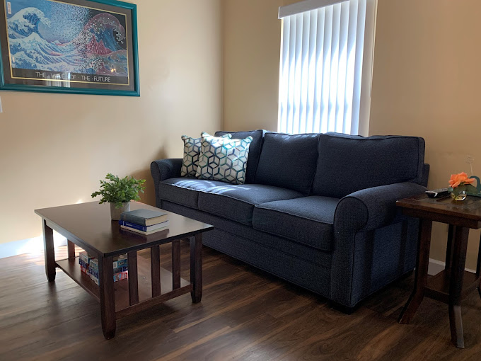 Sofa with coffee table and books in cozy room