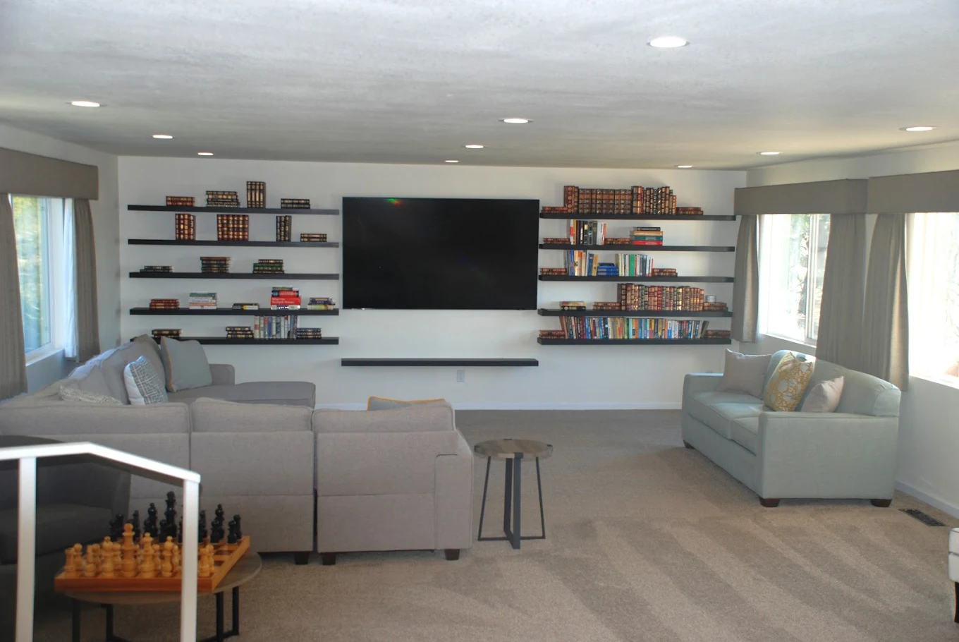 Wall-mounted TV with bookshelves and seating