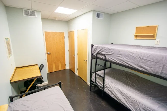 Shared dorm-style room with bunk beds and desk