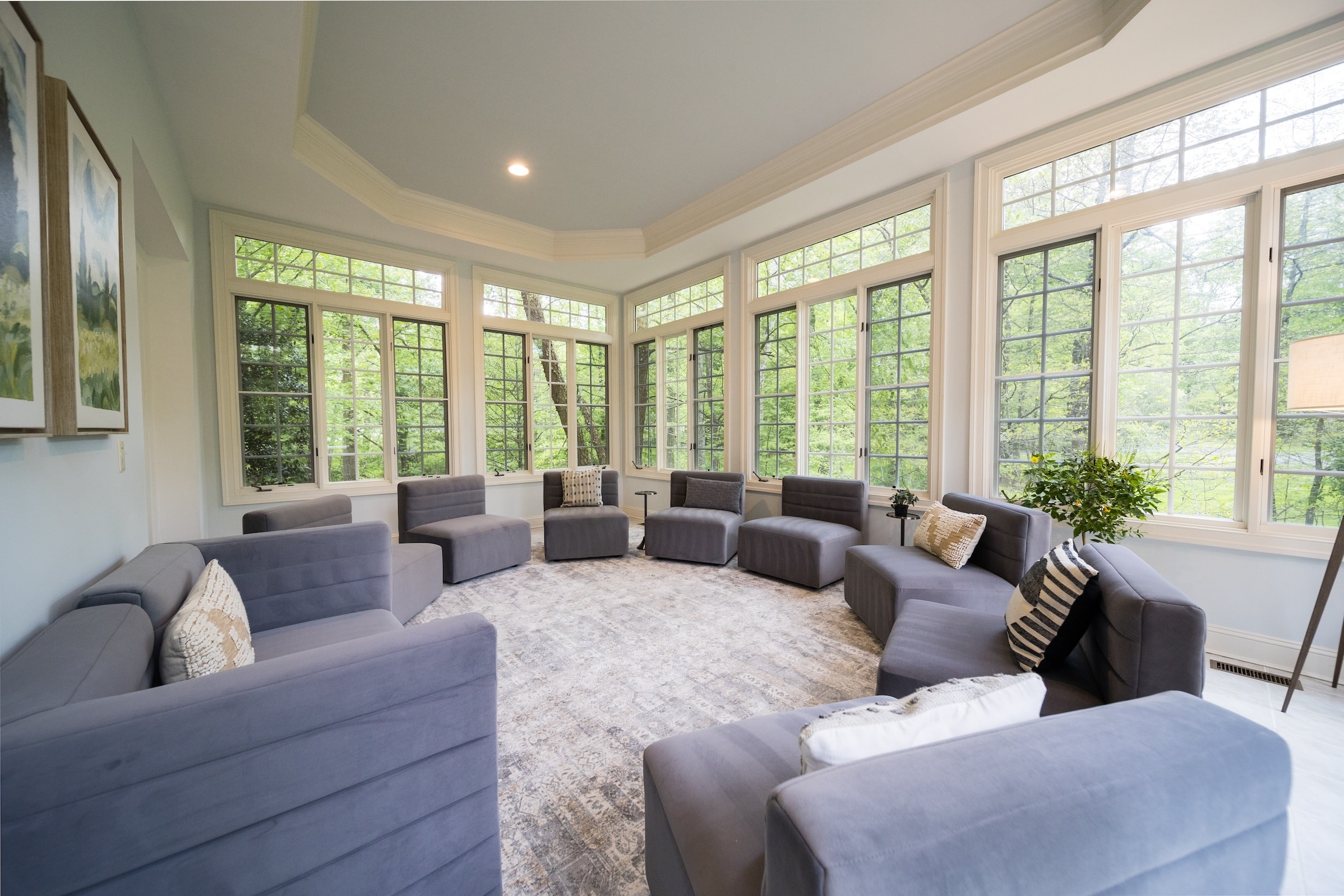 A sunlit therapy room with gray armchairs arranged in a circle