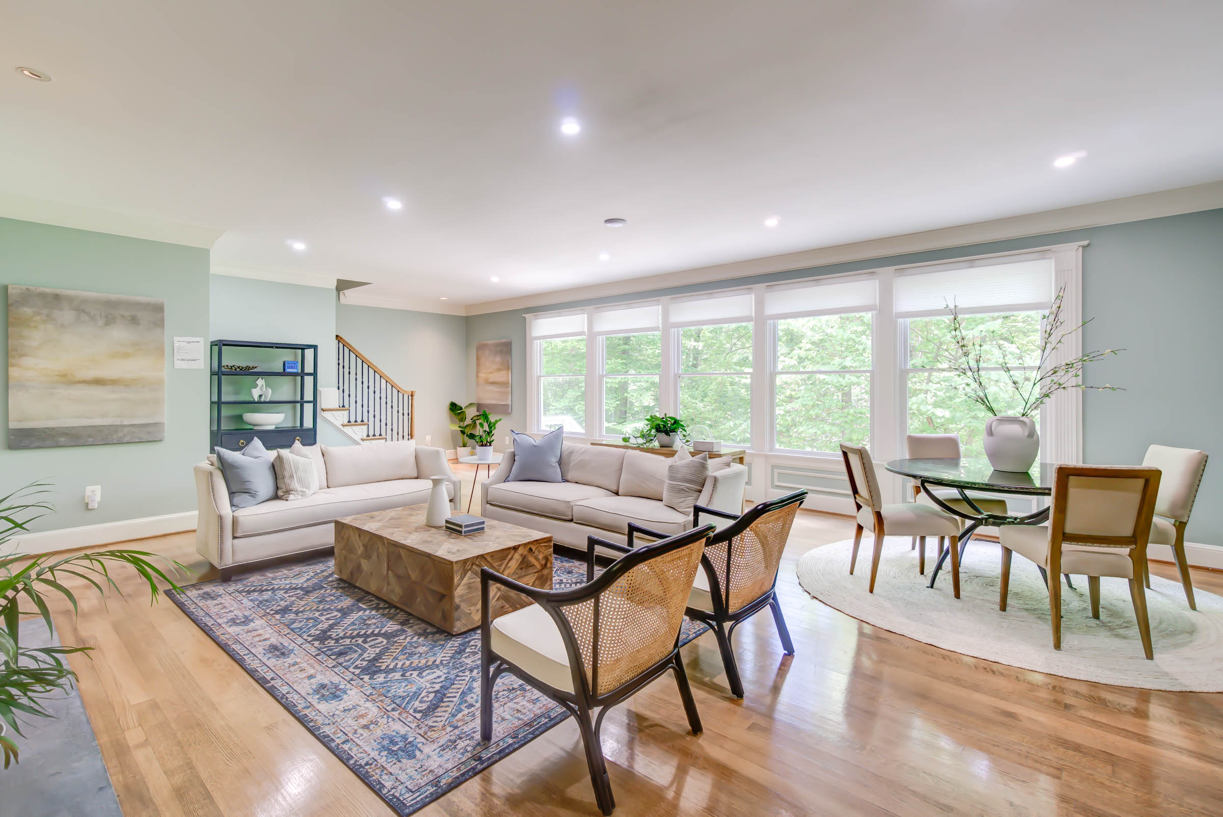 Bright living room with sofas and dining space.