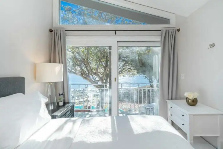 Bedroom with ocean view balcony at Cliffside Malibu treatment center