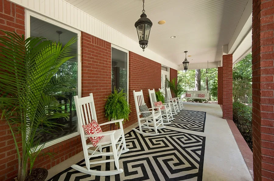 Covered porch with rocking chairs and outdoor seating