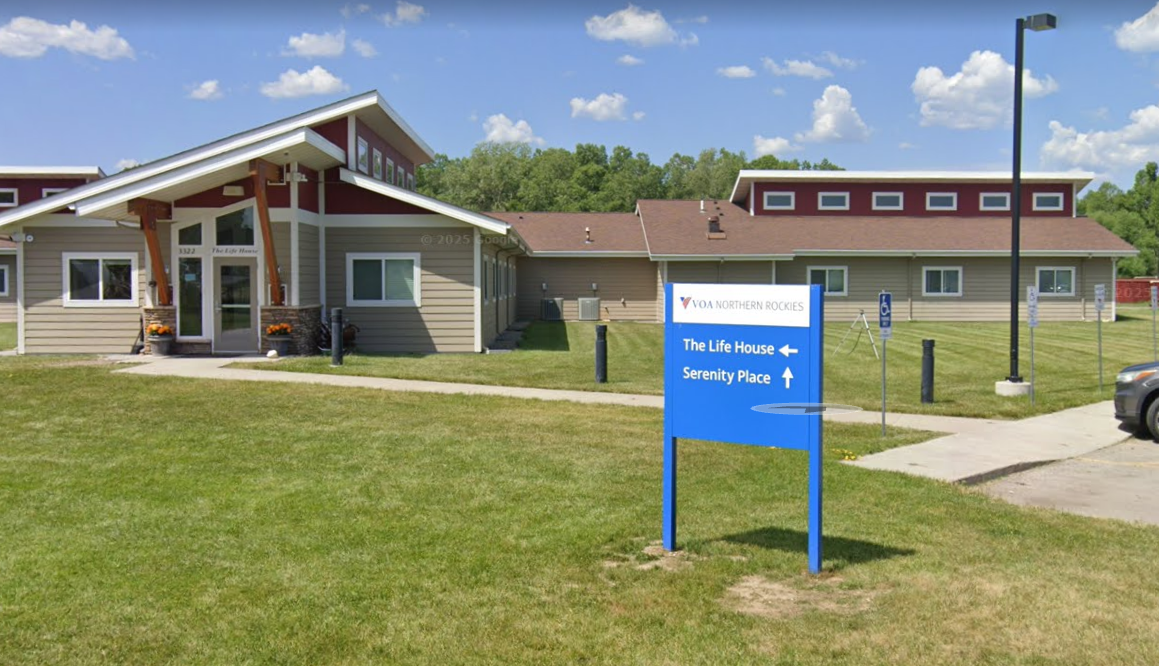 Life House building with blue directional sign on lawn