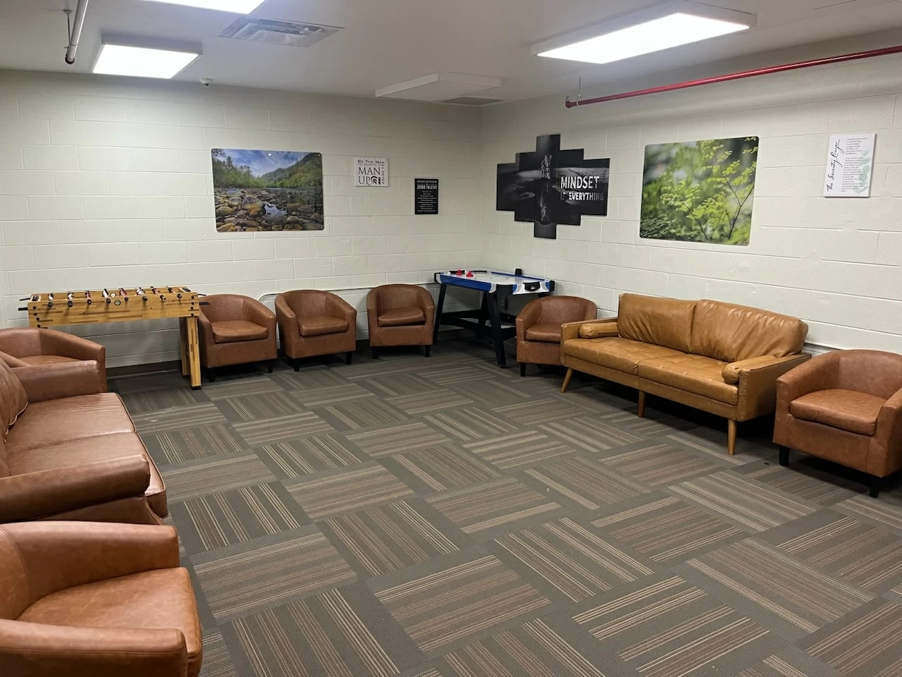 Recreation lounge with couches, foosball and air hockey tables