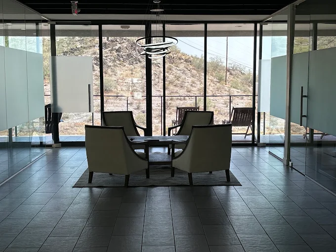 Four chairs by window with mountain backdrop