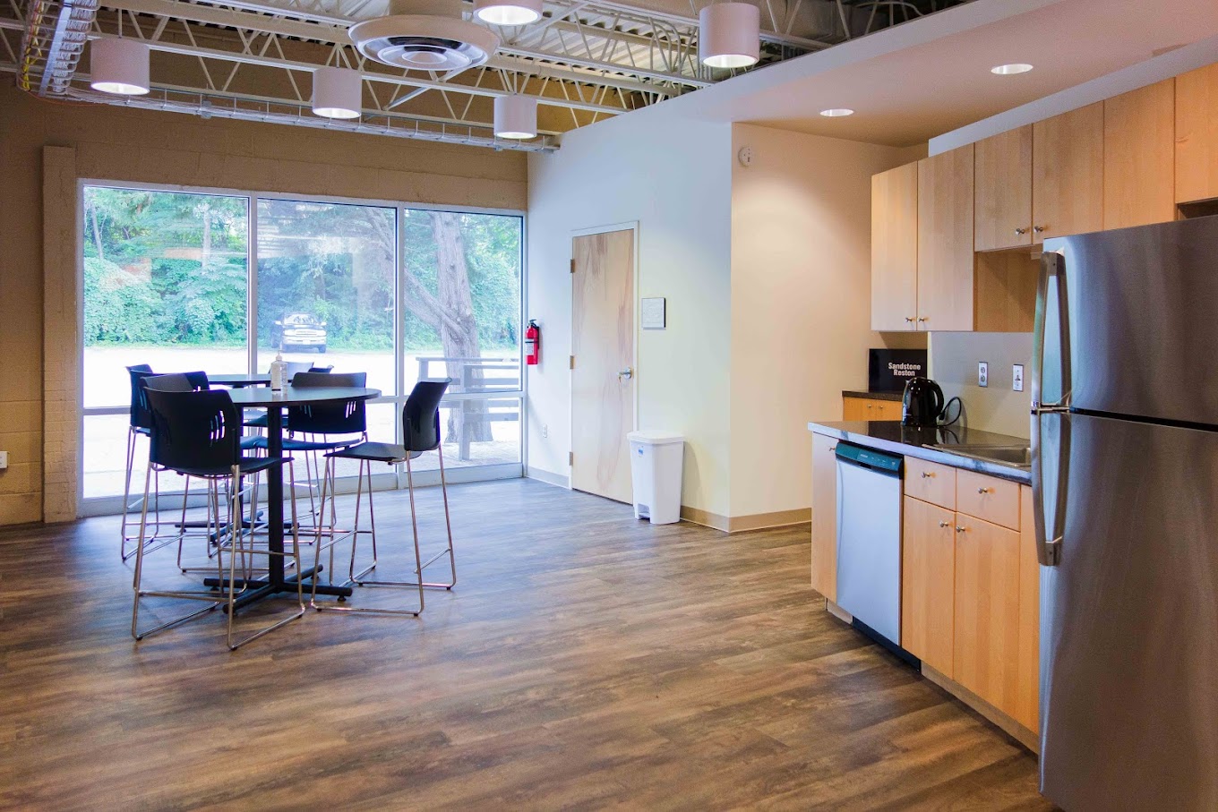 Cafeteria-style space offering tables, chairs, and shared dining.