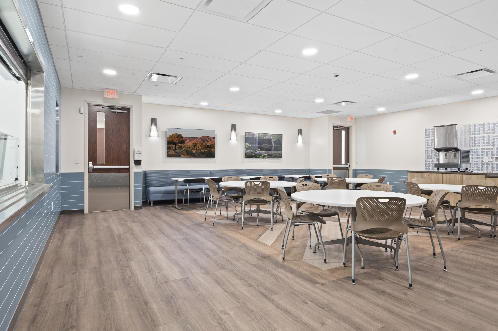 A clean, modern dining area with tables and chairs.