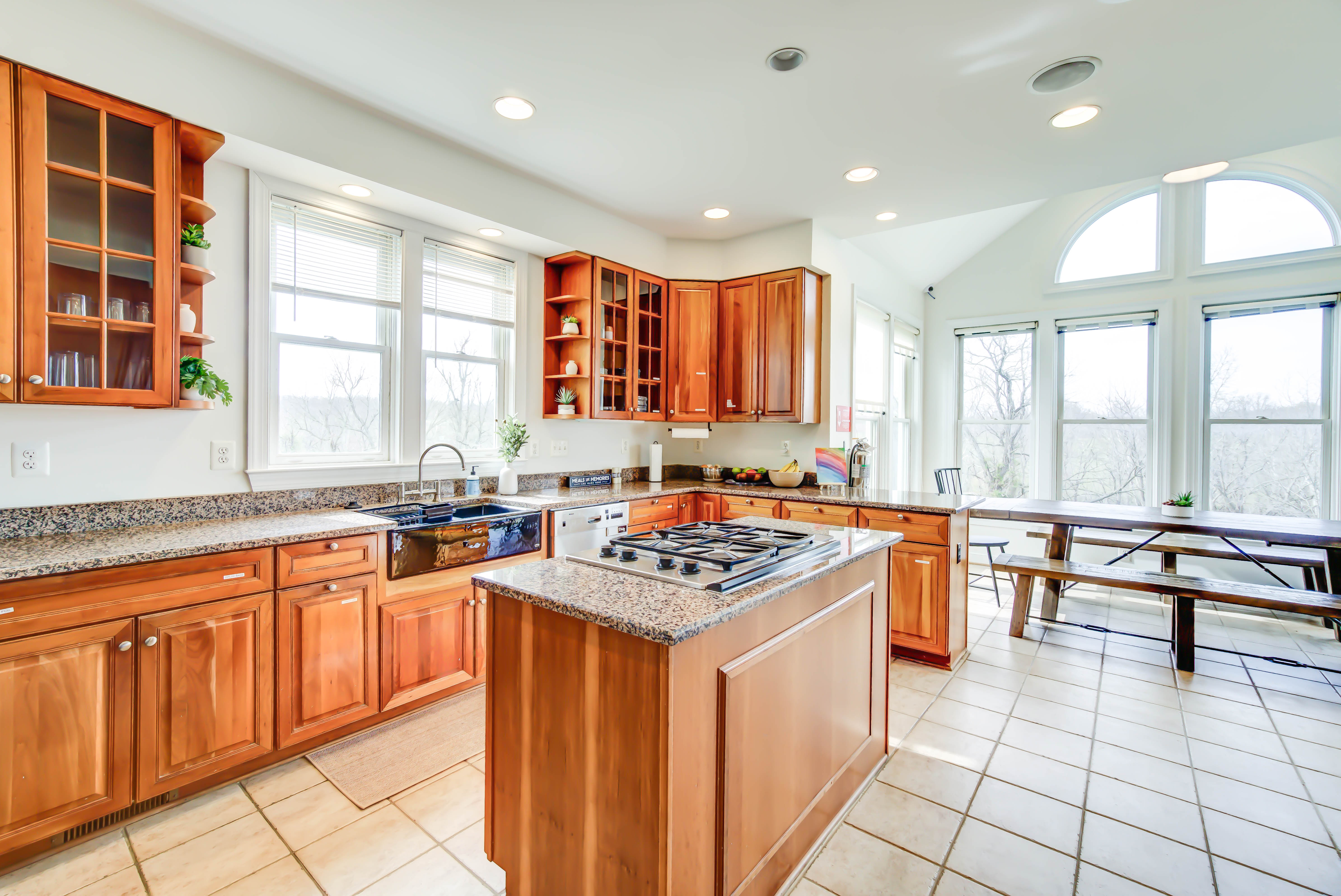 Spacious kitchen with wood cabinets and granite counters