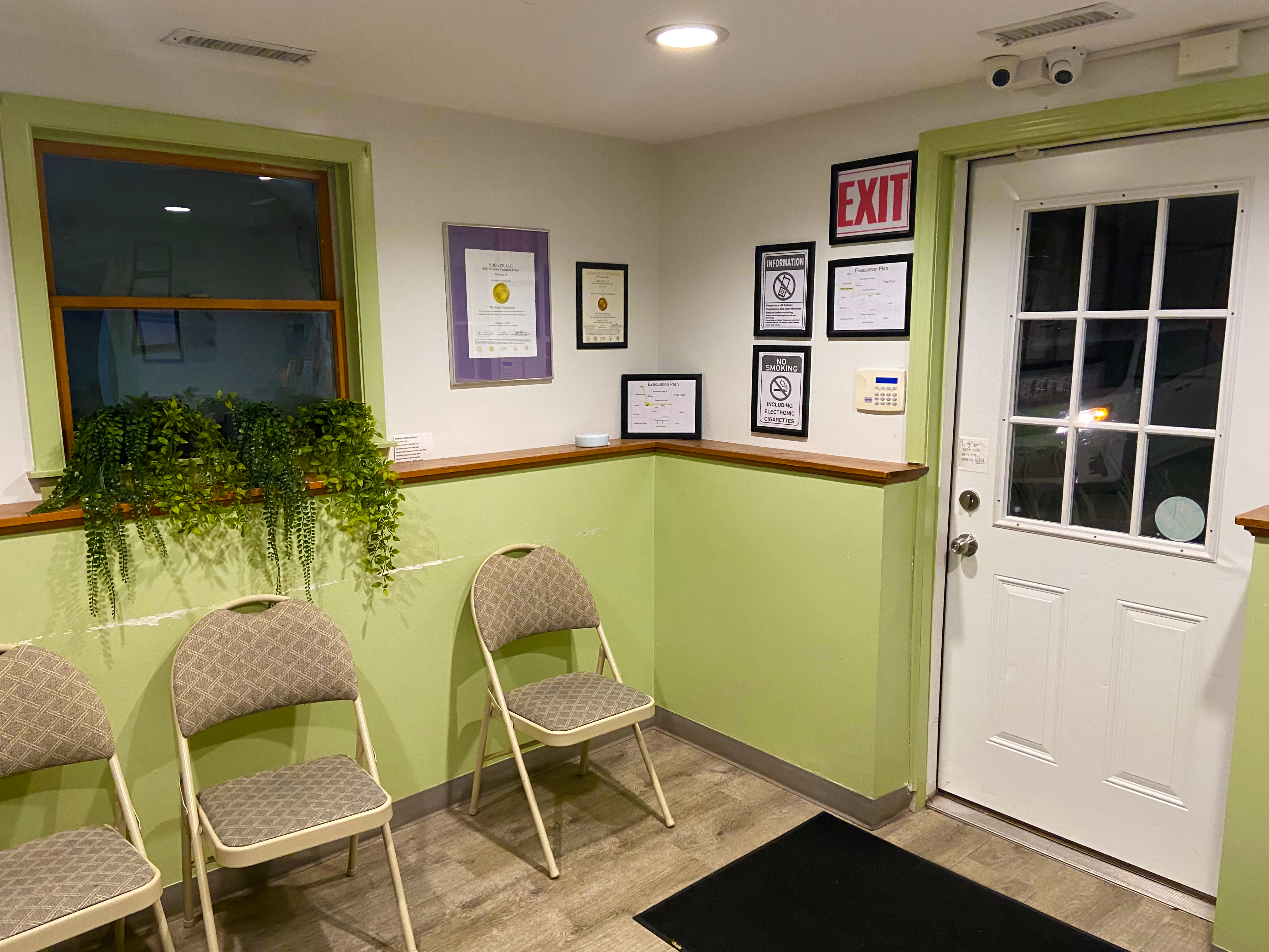 Lobby waiting area with chairs and reception entrance