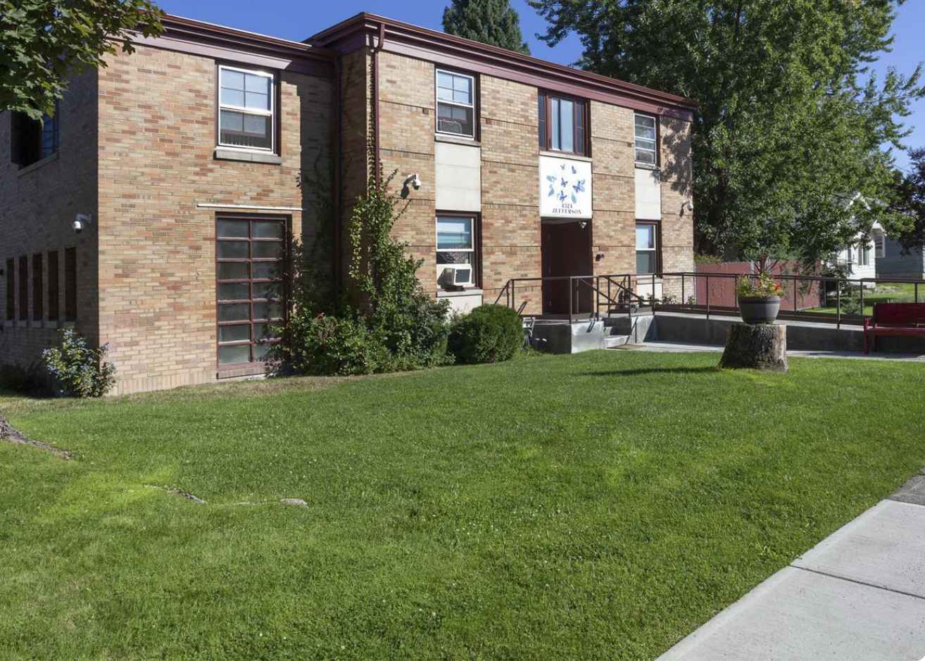 Brick building with grass lawn and accessibility ramp