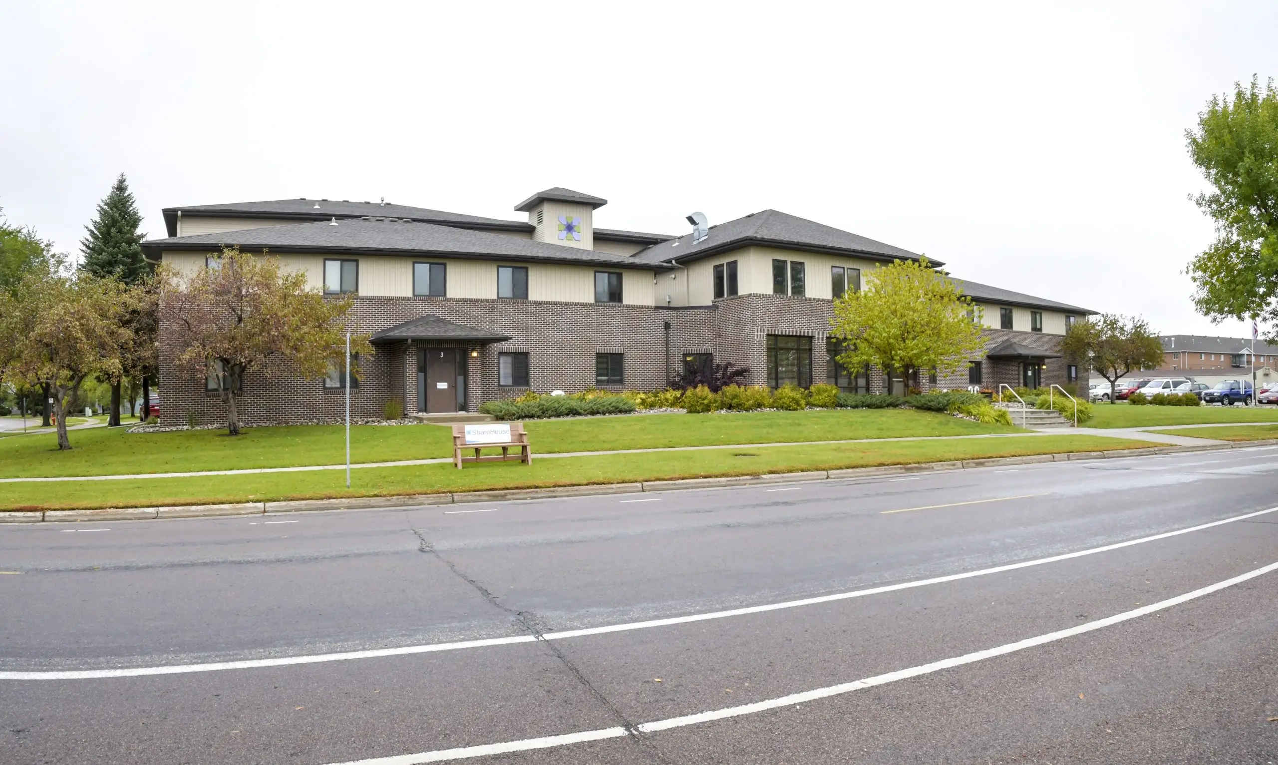 Two-story brick rehab center with landscaped lawn