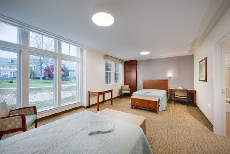 Bright bedroom with two beds and large windows