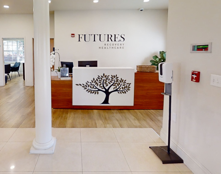Modern reception desk with tree logo and warm wood ton
